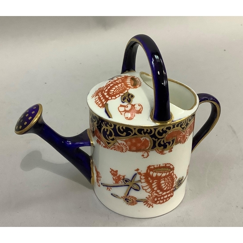 187 - A Royal Crown Derby miniature watering can together with various pill boxes in metal and pottery, tw... 