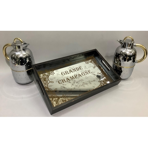 201 - A mirrored and black two-handled tray, rectangular, printed with Grande Champagne, together with two... 