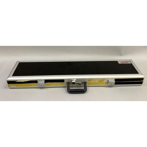 219 - A gun case by Americase, anodised metal and composite construction with black velvet partitioned int... 