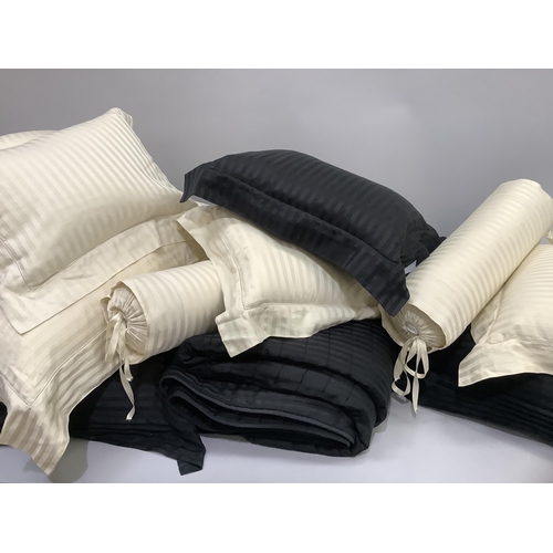 241 - A Pratesi Italian pure cotton bed set comprising a king size throw, two large black cushions and one... 