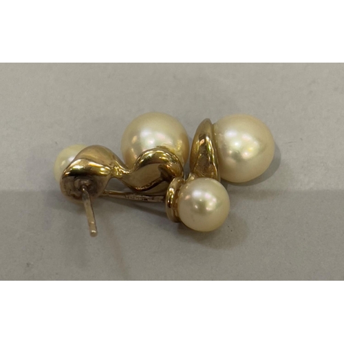 417 - A pair of cultured pearl ear studs in 9ct gold each set with 8mm and 6mm pearl, total approximate we... 