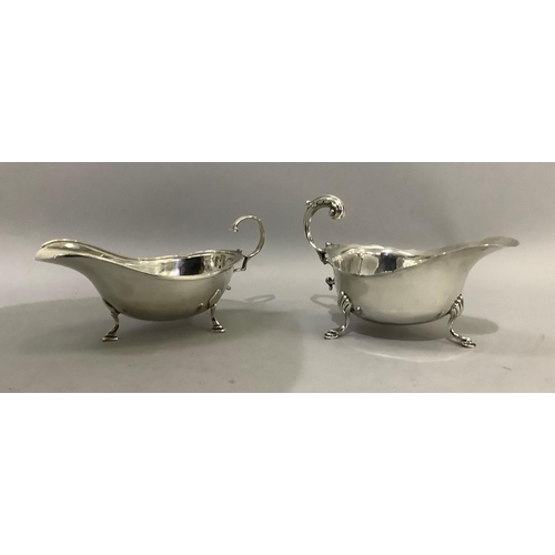 389 - Two silver sauceboats both with three pad feet and C scroll handles, Birmingham 1934 for SB & Co and... 