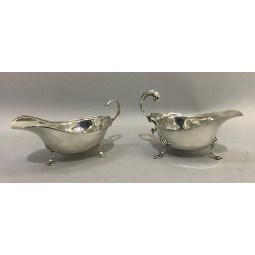 389 - Two silver sauceboats both with three pad feet and C scroll handles, Birmingham 1934 for SB & Co and... 