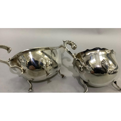 389 - Two silver sauceboats both with three pad feet and C scroll handles, Birmingham 1934 for SB & Co and... 