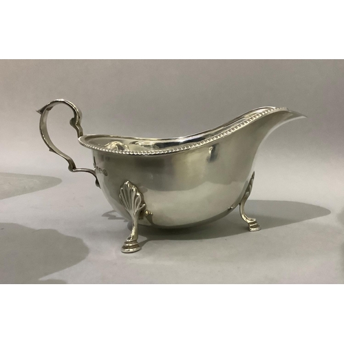 388 - A silver sauceboat by J R Ogden of Harrogate with three pad feet, C scroll handle and beaded rim, ap... 