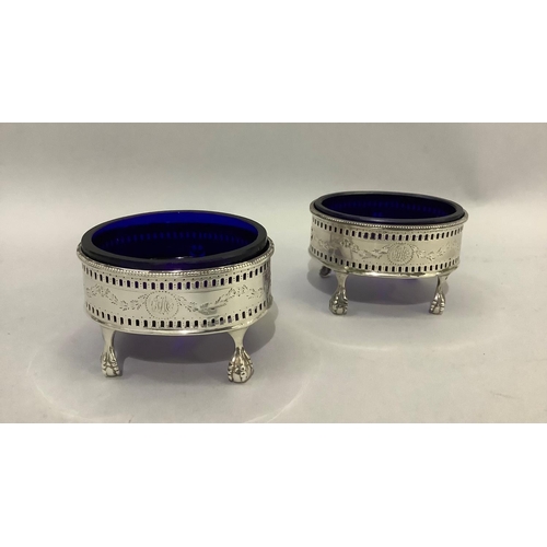 387 - A pair of George III silver salt cellars with blue glass liner, with pierced and engraved gallery wi... 