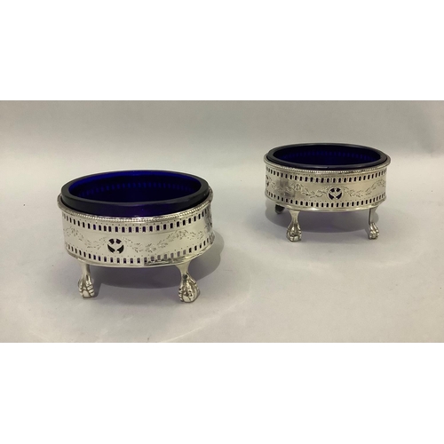 387 - A pair of George III silver salt cellars with blue glass liner, with pierced and engraved gallery wi... 