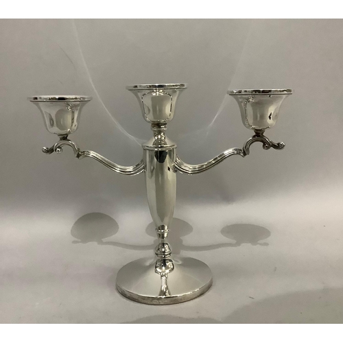 382 - A silver three branch candelabra with C scroll arms and weighted base, approximate height 20cm