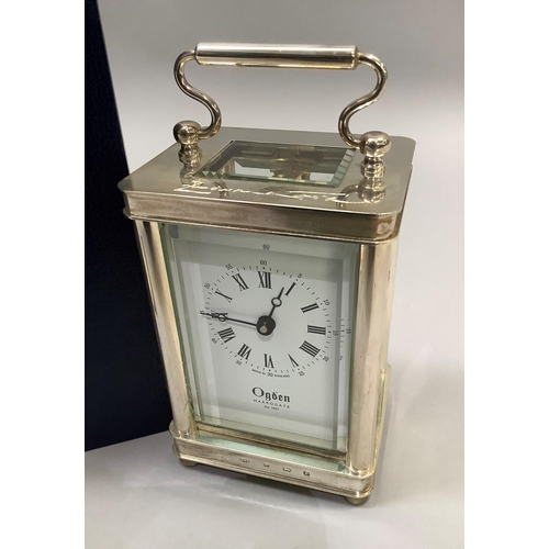 71 - A carriage  clock in silver case by Ogdens of Harrogate, Royal Hall Restoration Trust time piece wit... 