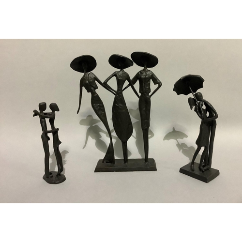 15 - Three metal sculptures of figure groups including three elegant ladies in large brimmed hats 26cm hi... 