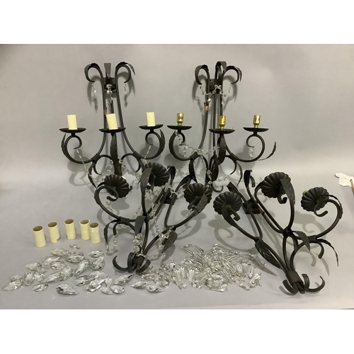 244 - A set of four triple light wall sconces, having three black wrought iron scrolled branches with leaf... 