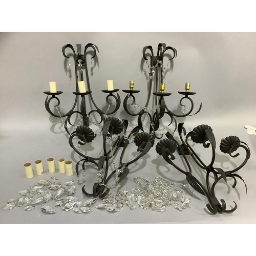 244 - A set of four triple light wall sconces, having three black wrought iron scrolled branches with leaf... 