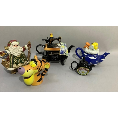 48 - Five novelty teapots including sewing machine, Father Christmas, Marmite, Tigger and Tweetie Pie