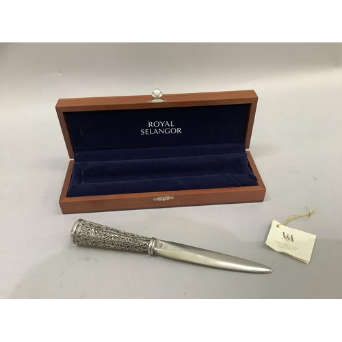 73 - A Royal Selangor pewter paper knife, the handle chased with stylised flowers contained in a blue vel... 