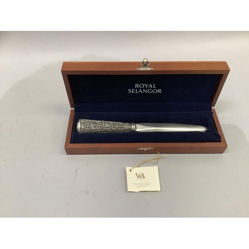 73 - A Royal Selangor pewter paper knife, the handle chased with stylised flowers contained in a blue vel... 