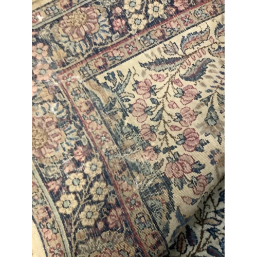 110 - A pair of Persian style rugs, the ivory ground woven with a design of blossom in blue, rose, ochre a... 