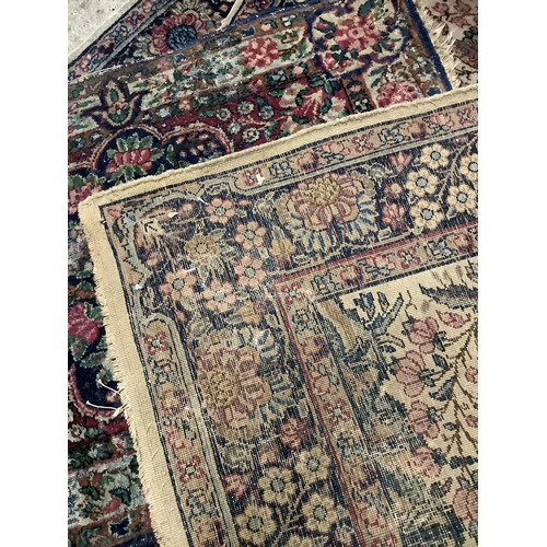 110 - A pair of Persian style rugs, the ivory ground woven with a design of blossom in blue, rose, ochre a... 