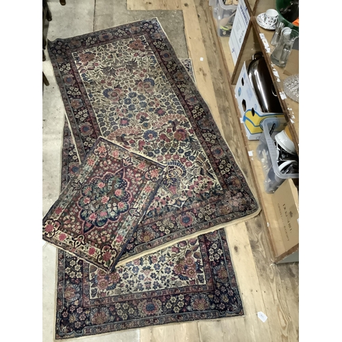 110 - A pair of Persian style rugs, the ivory ground woven with a design of blossom in blue, rose, ochre a... 