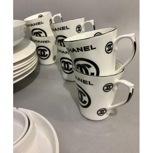 247 - A selection of tableware including a set of six Chanel motif coffee mugs, a Jeff & Co teardrop shape... 