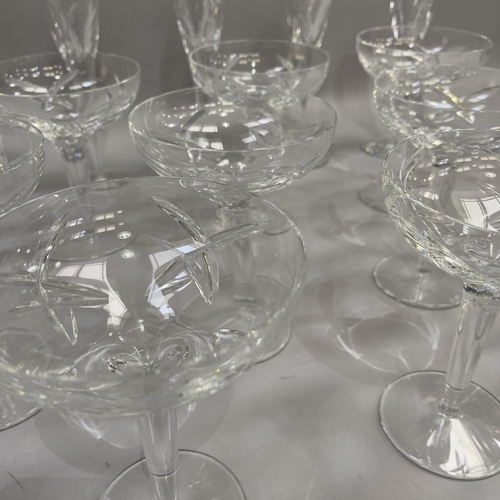 33 - A suite of twelve Waterford Champagne coupes and six matching flutes, measuring 16cm and 26cm high