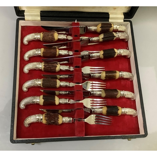 64 - A cased set of six silver plated and faux horn handled steak knives and forks