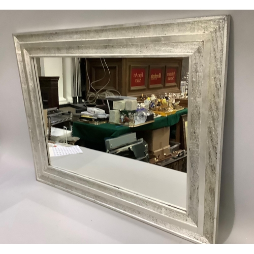 306 - A rectangular wall mirror with silver effect frame, 85cm x 110cm approximately