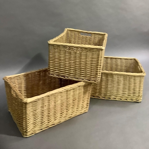 307 - A set of three wicker baskets, 59cm x 44cm x 30cm high