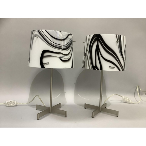 313 - A pair of AV Mezzega Murano glass table lamps, the shades having swirls of black on white, on a brus... 