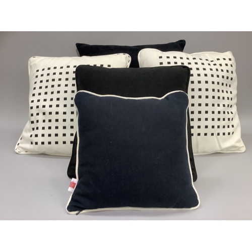 316 - Five various cushions including two black in graduated size, a pair of white and black and a small c... 