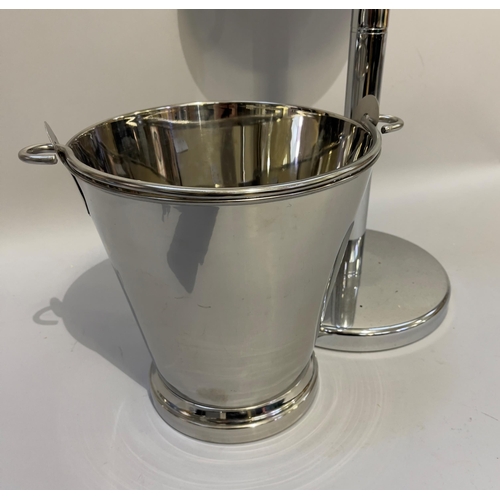 318 - A polished steel champagne bucket and stand, 87cm high