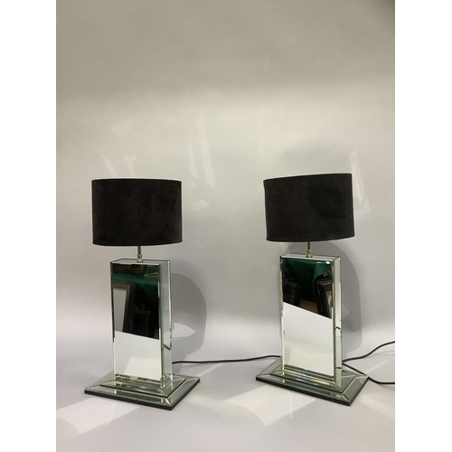 323 - A pair of mirrored table lamps of rectangular form, on stepped base and with black drum shades, 57cm... 