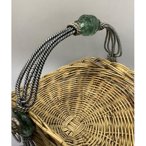 329 - A wicker log basket with metal rope style handle with lion face mask decoration