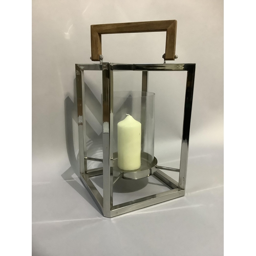 336 - A candle lantern with glass and chrome frame and wooden handle, 45cm x 29cm