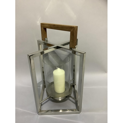 336 - A candle lantern with glass and chrome frame and wooden handle, 45cm x 29cm