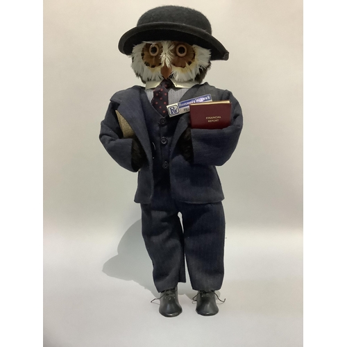 339 - A figure of an owl wearing a bowler hat and suit, 47cm high