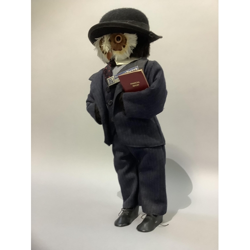 339 - A figure of an owl wearing a bowler hat and suit, 47cm high