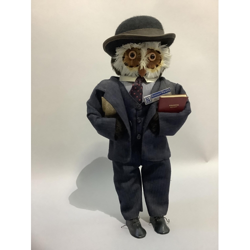 339 - A figure of an owl wearing a bowler hat and suit, 47cm high