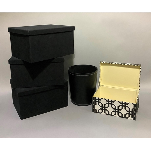 342 - A set of three black cardboard boxes, a white box and a black leather waste bin