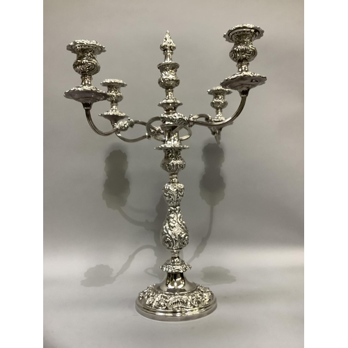 366 - A quality silver plated five light candelabra having a central baluster and foliate embossed single ... 