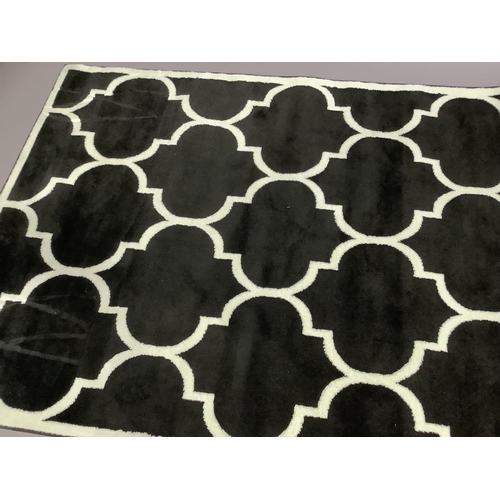 375 - A black and white rug, 140cm x 200cm