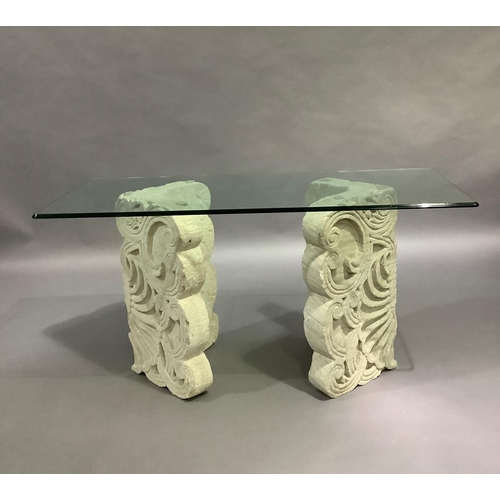 439 - A Spanish glass topped console table, rectangular, on two stone effect V shaped pillars, 148cm wide ... 