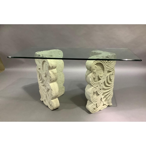 439 - A Spanish glass topped console table, rectangular, on two stone effect V shaped pillars, 148cm wide ... 