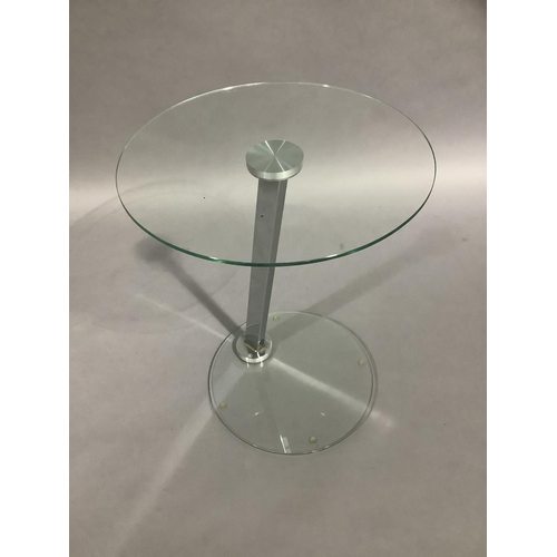 457 - A glass topped occasional table of circular outline on a chrome support and glass circular base, 43c... 