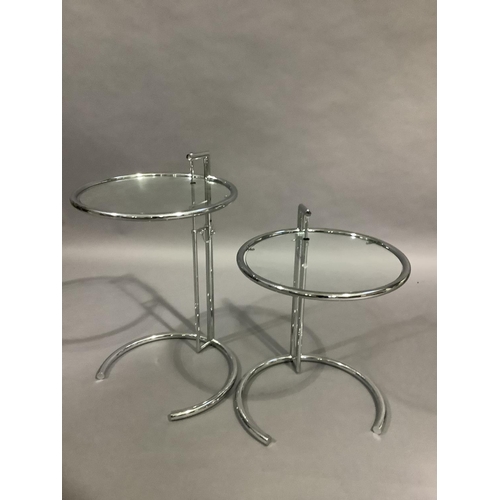 458 - A pair of chrome and glass circular occasional tables on telescopic stands and curved foot, 51cm dia... 