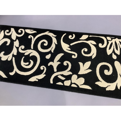 460 - A black and cream runner, 230cm x 60cm