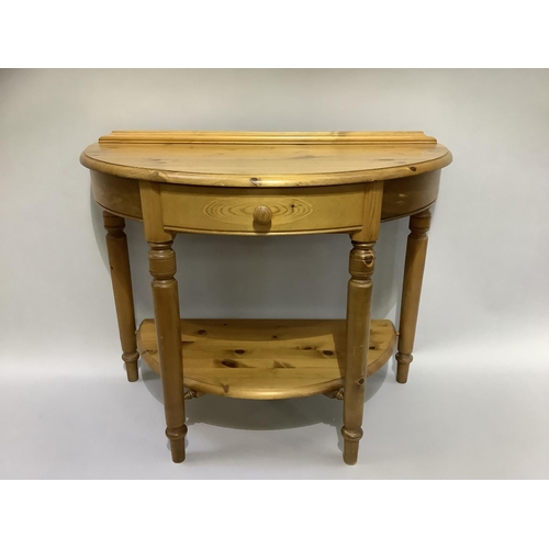 163B - A pine demi-lune side table with centre drawer and under tier, on turned legs, 90cm wide x 49cm deep... 