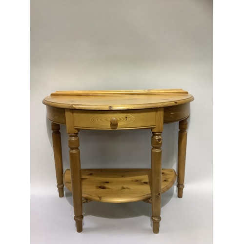 163B - A pine demi-lune side table with centre drawer and under tier, on turned legs, 90cm wide x 49cm deep... 