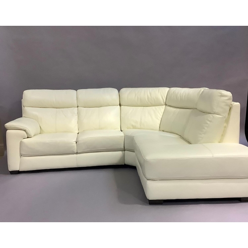 461 - A cream leather corner sofa in three sections, and a matching armchair, all on dark stained block fe... 