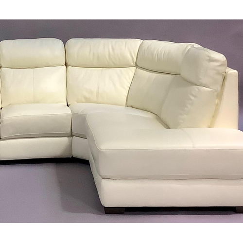 461 - A cream leather corner sofa in three sections, and a matching armchair, all on dark stained block fe... 