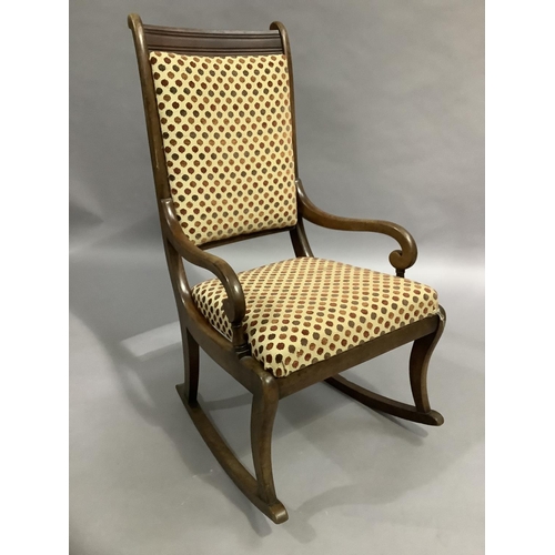 468 - A Victorian mahogany rocking chair, upholstered in velvet spot fabric